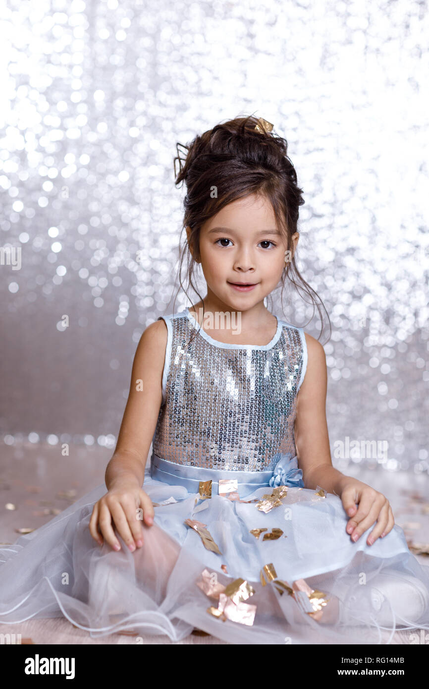 little girl in blue dress sitting on the floor with confetti Stock ...