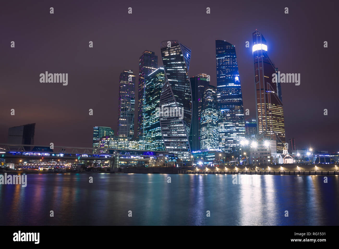 Moscow city night view with skyscrapers and a futuristic bridge over the river Stock Photo