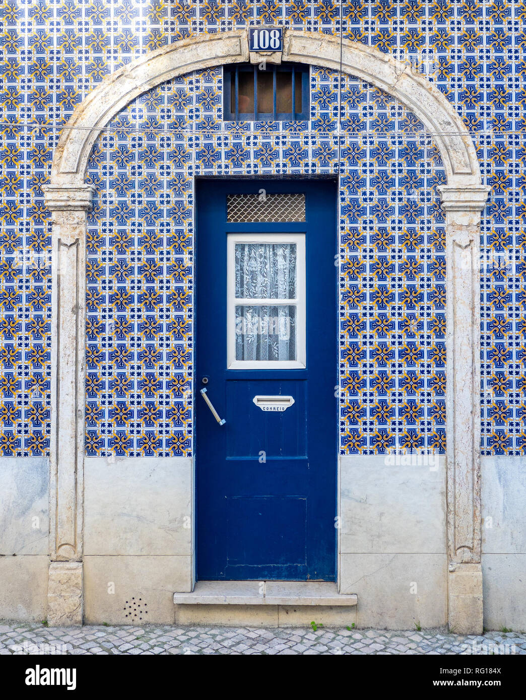 Traditional portuguese lisbon house wooden door with azulejos ceramic tiles surrounding Stock Photo