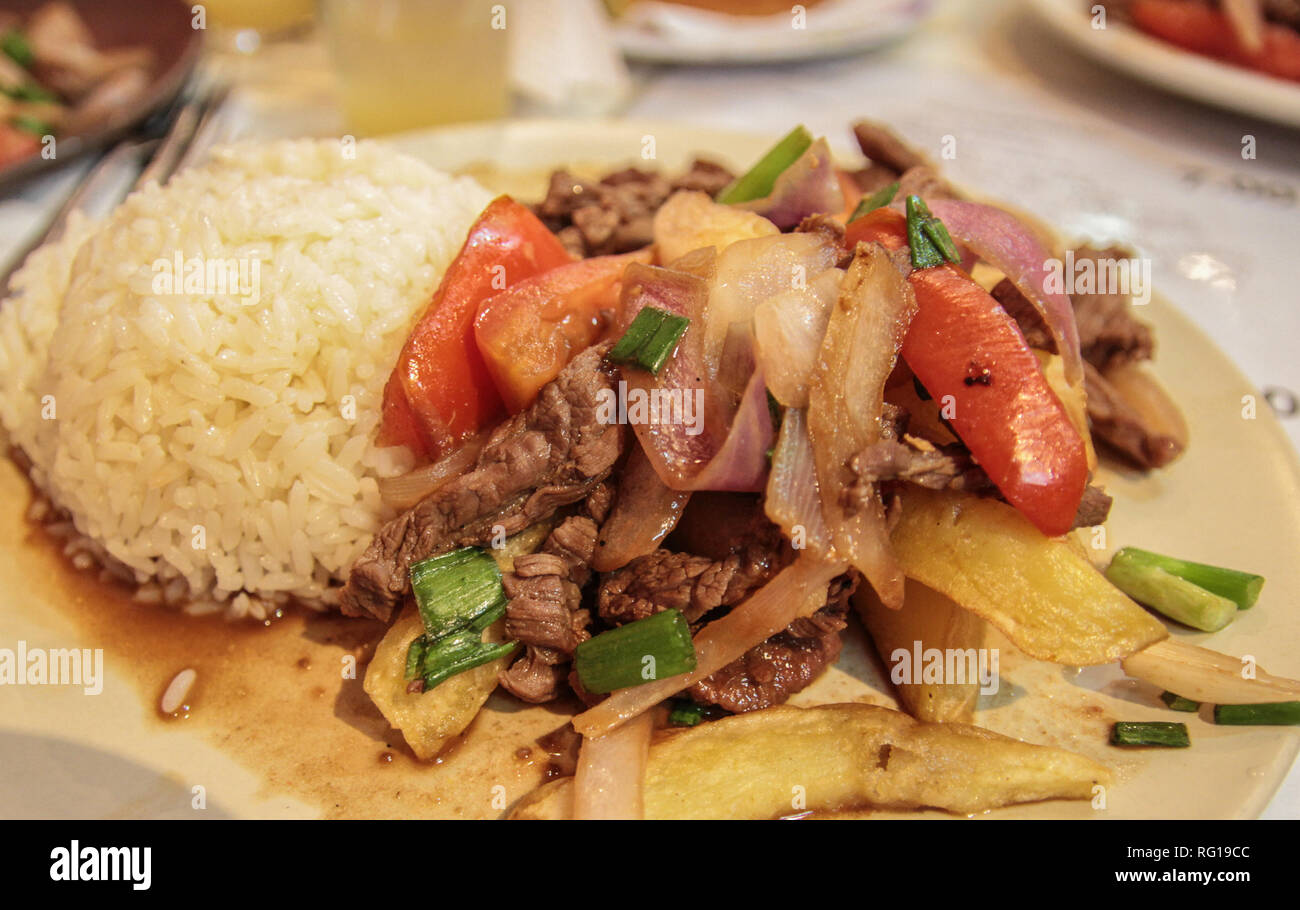 Lomo saltado, traditional dish at Peru including beef, tomato and potato Stock Photo