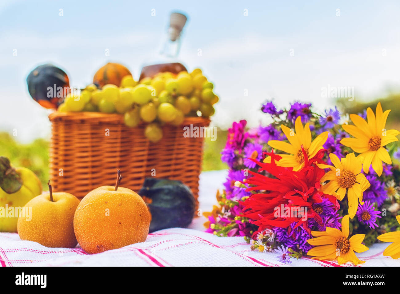 Picnic set with wine flowers and fruit Stock Photo Alamy