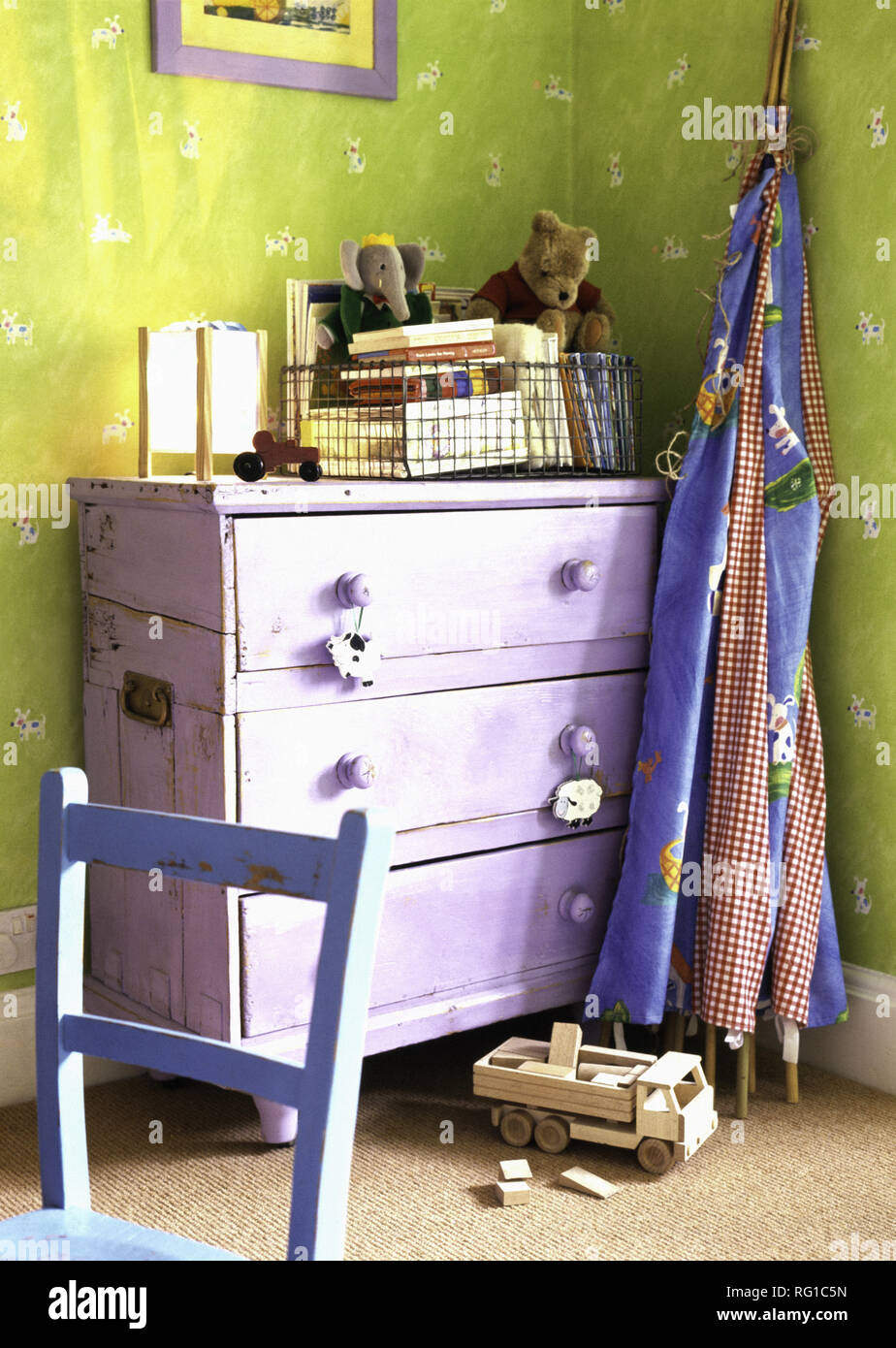 Mauve Painted Chest Of Drawers In Child S Green Bedroom Stock