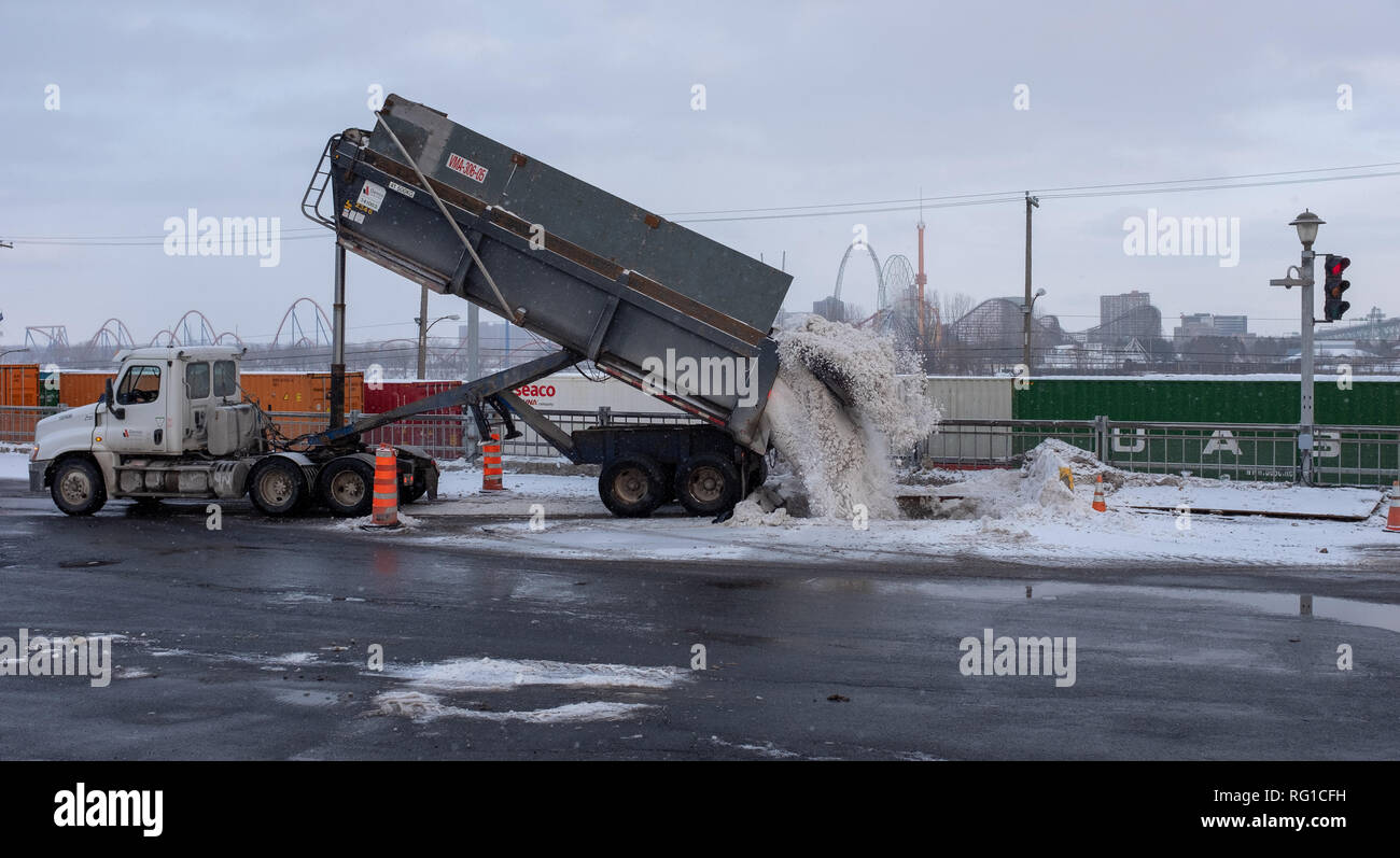 Truck dumping snow after a snow removal operation Stock Photo