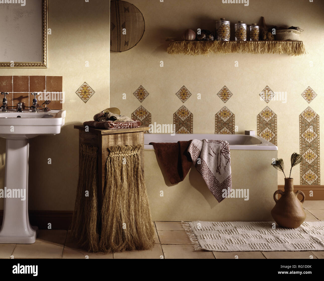 Cabinet with raffia trimming in African style bathroom Stock Photo