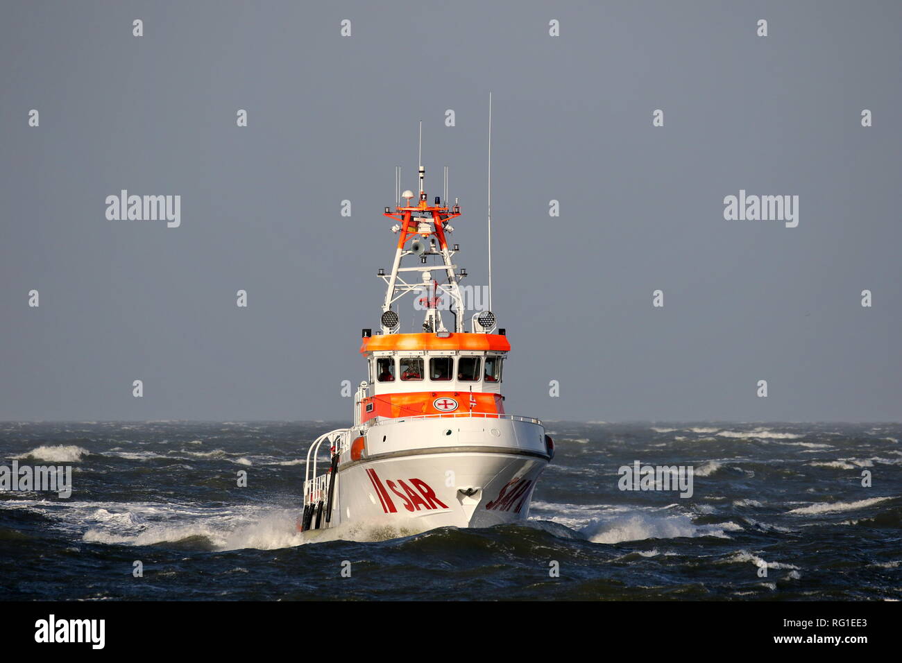 The SAR ship Anneliese Kramer passes on January 1, 2019 the port of Cuxhaven in a stormy sea. Stock Photo