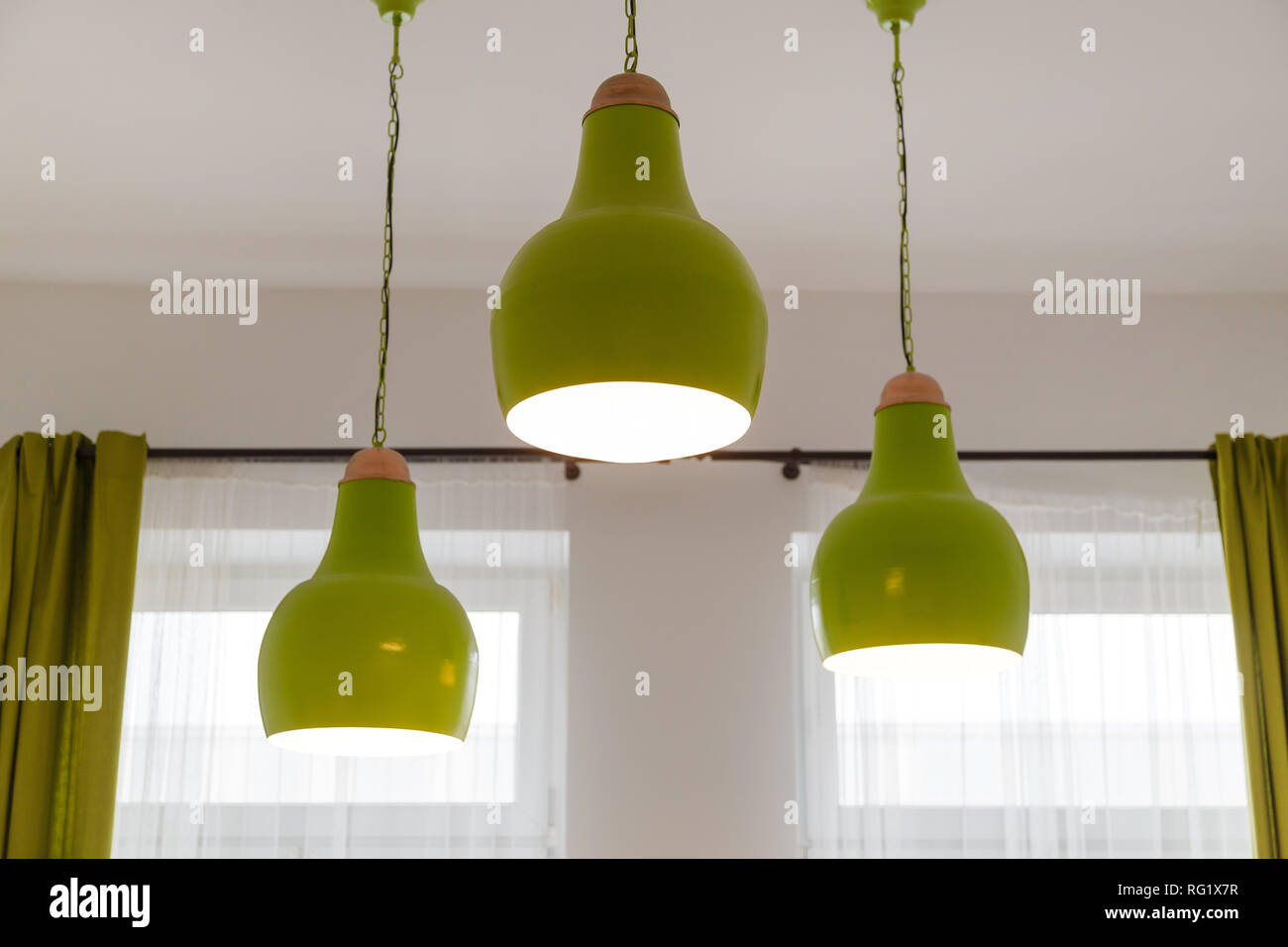 Three ceiling green lamps in white interior Stock Photo Alamy