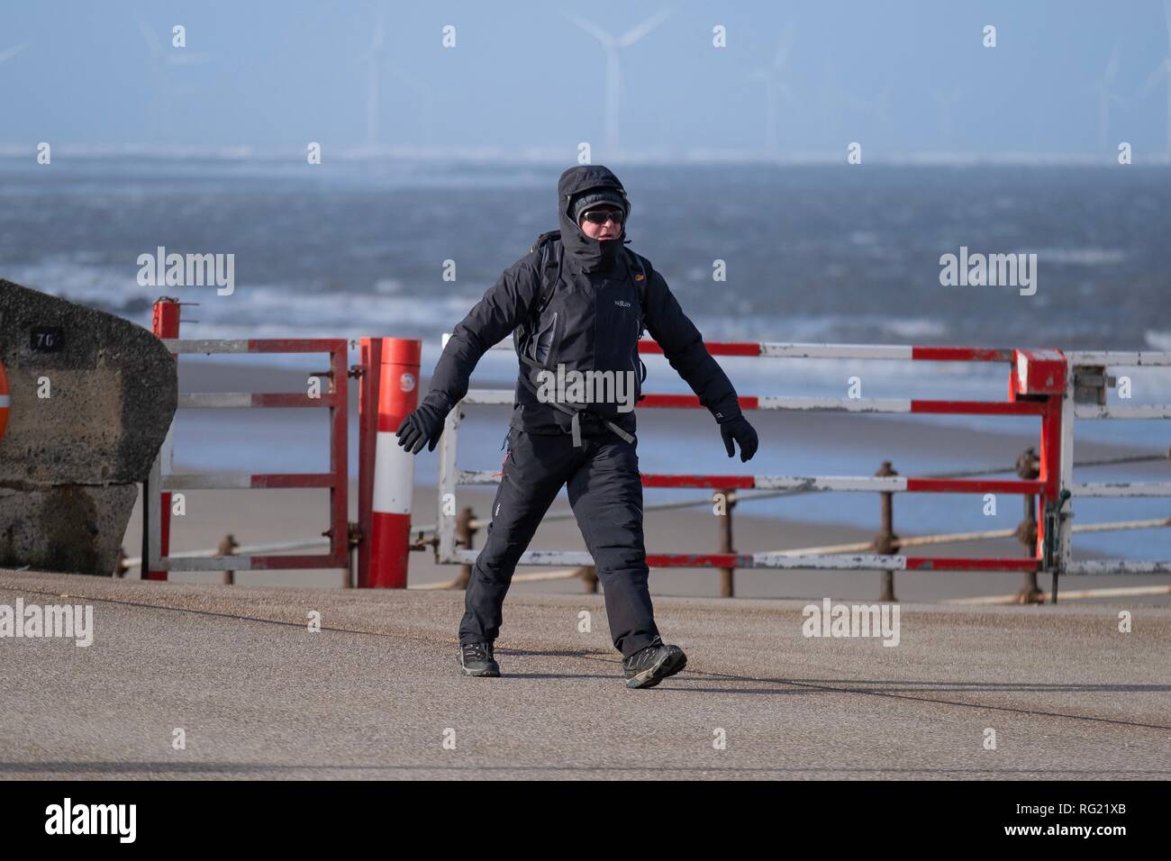 New Brighton, Wirral, UK. 27th January, 2019. People struggling in the windy weather conditions at New Brighton promenade on the Wirral on Sunday, January 27, 2019. Credit: Christopher Middleton/Alamy Live News Stock Photo