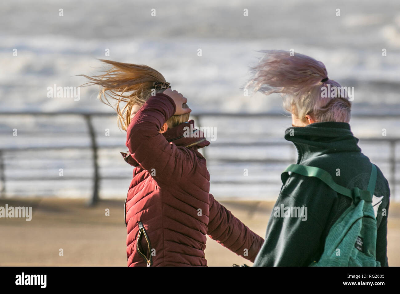 Blackpool, Lancashire. 27th Jan, 2019. UK Weather. Gale force winds at the coast. Visitors to the seaside town have to endure severe winds with pedestrians being blown over on the seafront promenade. Storm , blow, tempest, flyaway hair, tangled tresses, bad hair day on the seafront promenade.Credit:MediaWorldImages/AlamyLiveNews Stock Photo