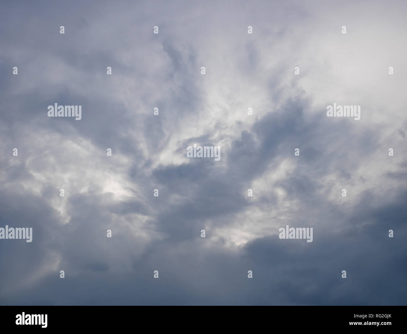 Grey and bluish dramatic cloudscape with various density chaotic thunderclouds Stock Photo