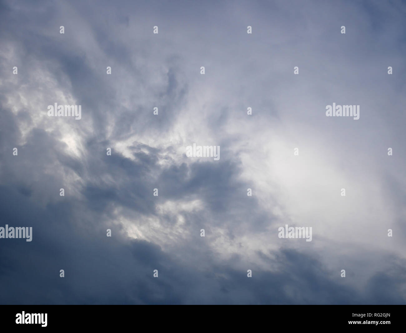 Dark and light bluish tragic cloudscape with various density chaotic thunderclouds Stock Photo