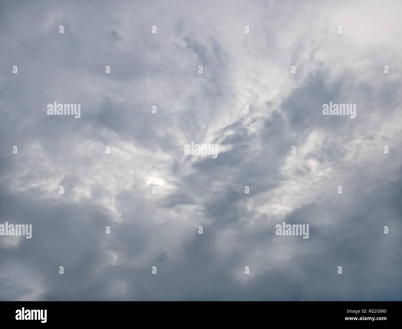 Grey and bluish tragic cloudscape with various density chaotic clouds Stock Photo