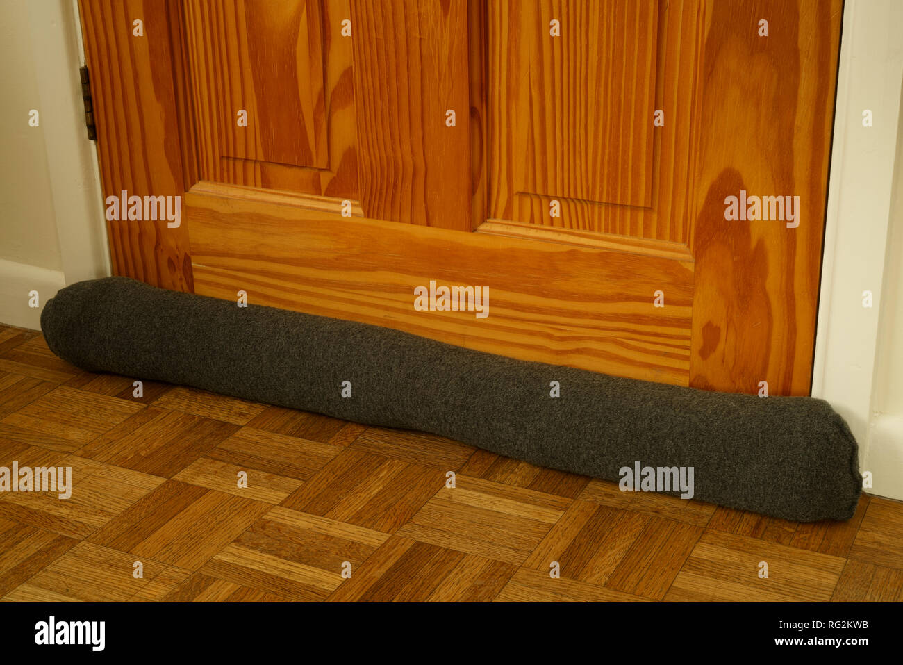 Draught excluder at the base of a door Stock Photo Alamy