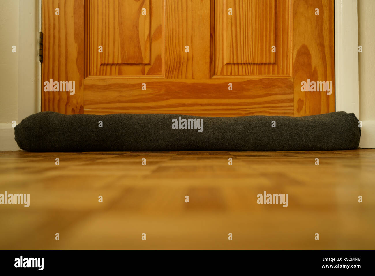 Draught excluder at the base of a door Stock Photo Alamy