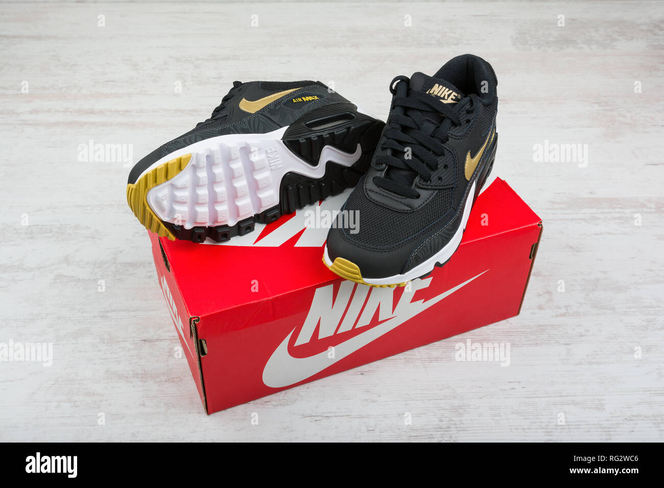 BURGAS, BULGARIA - DECEMBER 30, 2016: Nike Air MAX women's shoes - sneakers  in black, on white wooden background. Nike is a global sports clothes and  Stock Photo - Alamy