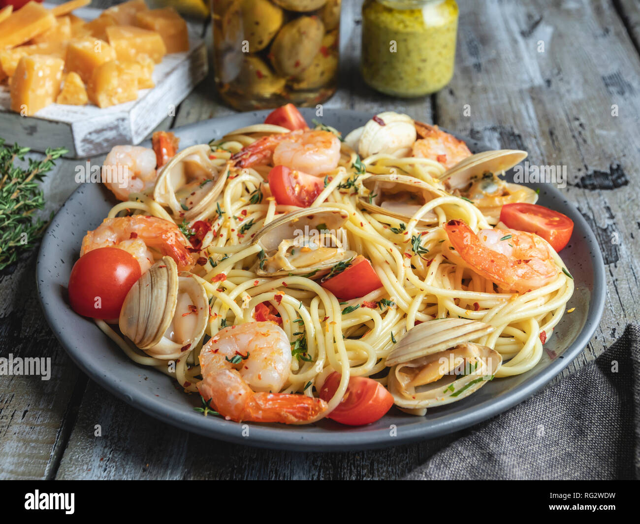 Cooked pasta with seafood clams, shrimps tomato on a plate , spaghetti Stock Photo