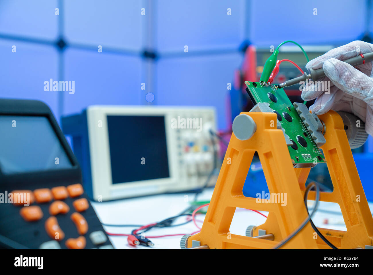 Fixing electronics PCB board in service /  workbench with electronics measuring instruments Stock Photo