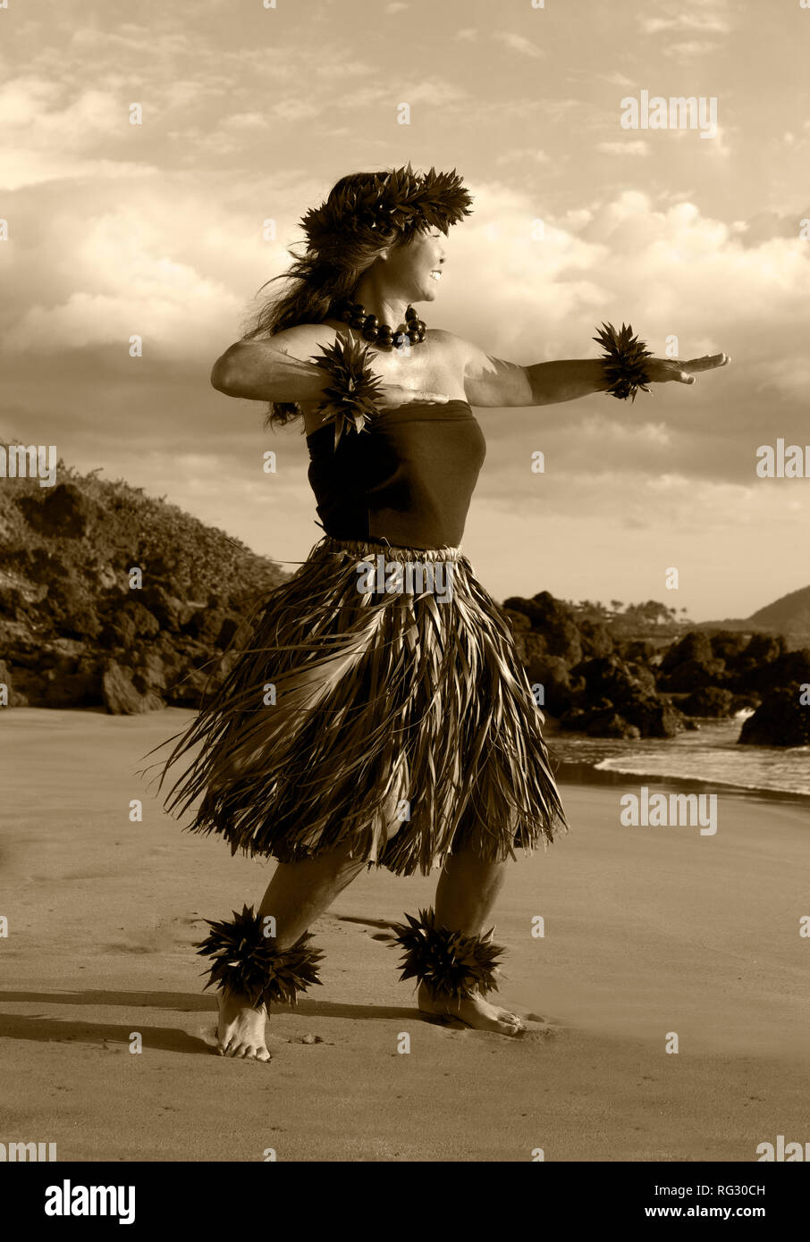 Female hula dancer on the beach at Chang's Beach, Maui, Hawaii. Stock Photo