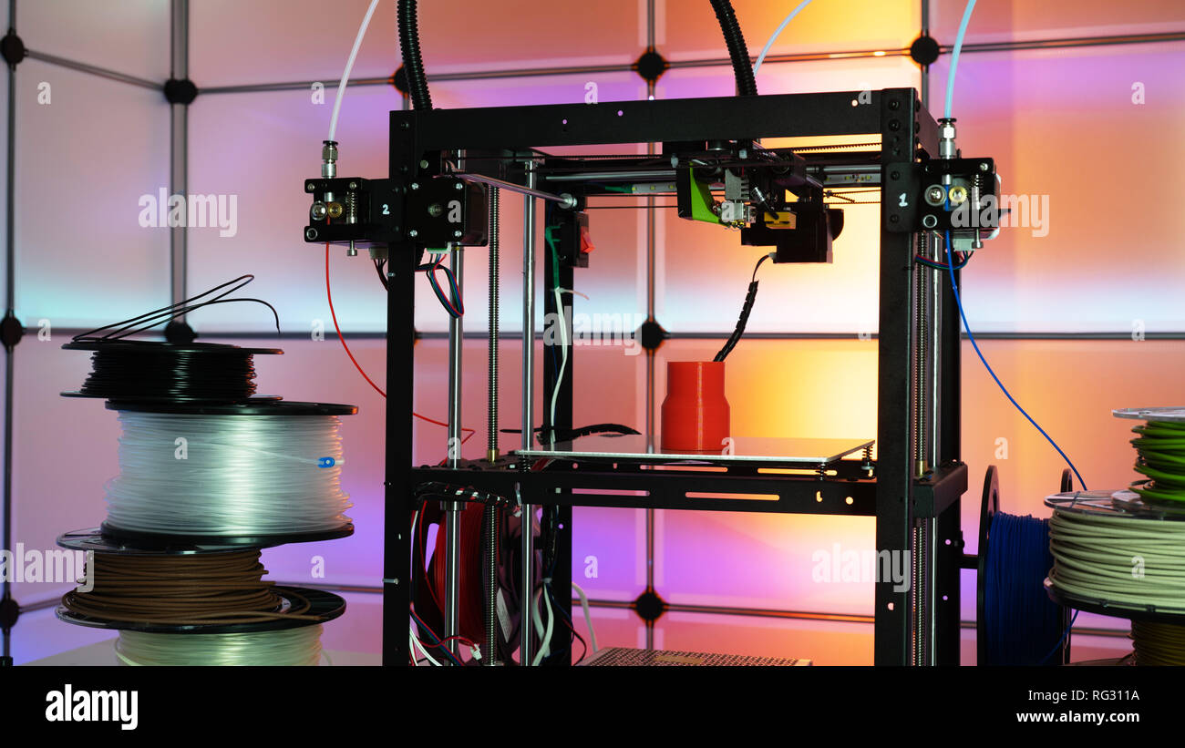 3d printer and plastic filament on color background Stock Photo