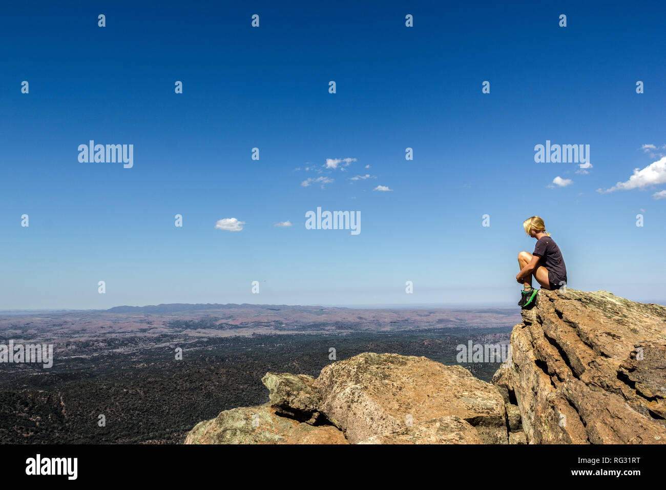 jung women sitting on St Mary's Peak from the Flinders Ranges National Park Stock Photo
