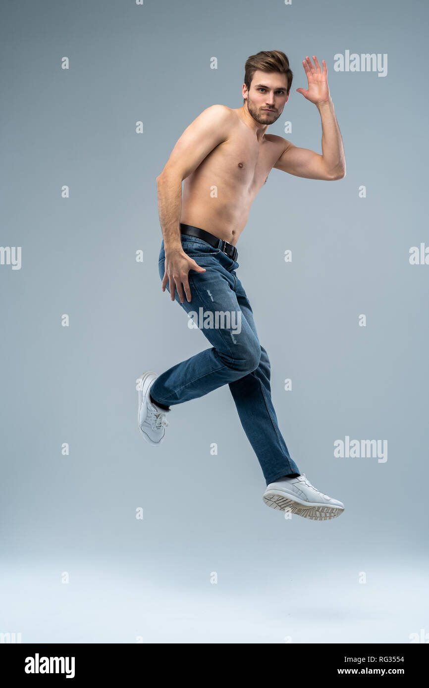 Full-length photo of funny man running or jumping in air isolated over gray background Stock Photo - Alamy Full-length photo of funny man running or jumping in air isolated over gray background Stock Photo - Alamy
