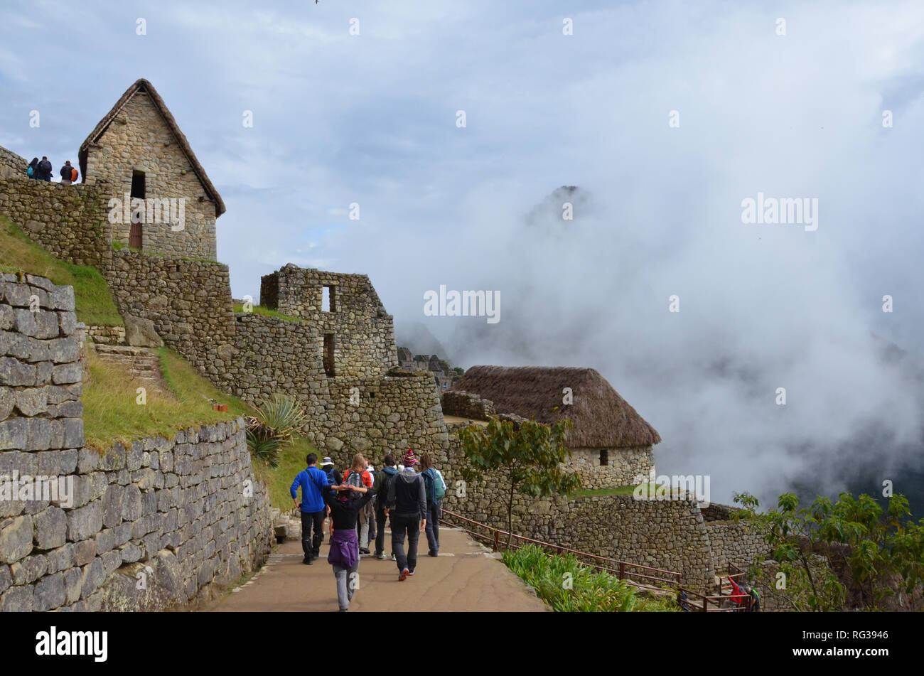 MACHU PICCHU / PERU, August 16, 2018: Tourists walk amid the ruins of Machu Picchu. Stock Photo