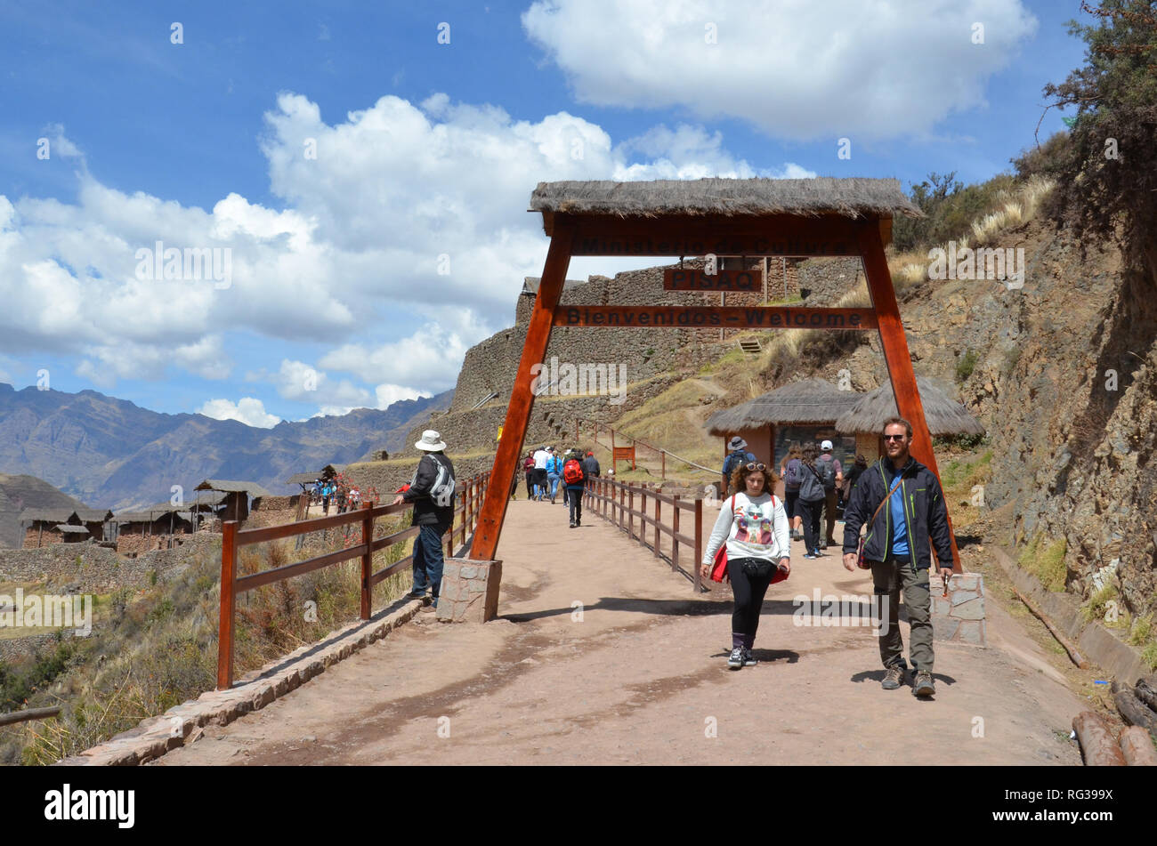 PISAQ / PERU, August 16, 2018: Tourists walk through the entrance gate to the ruins of Pisaq near Cusco. Stock Photo