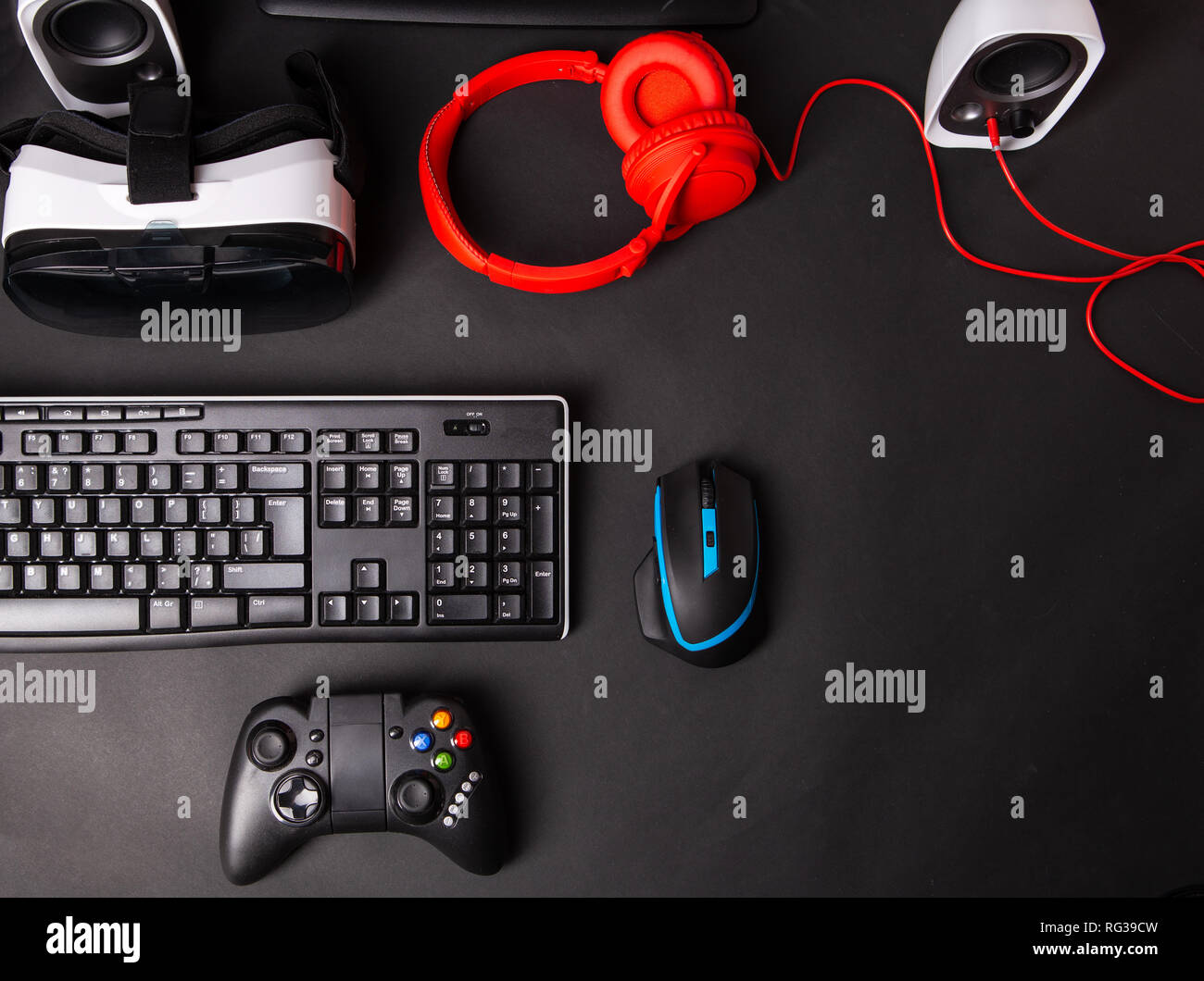 Top view a gaming gear, mouse, keyboard, joystick, headset, VR Headset on  black table background. Gamer workspace concept Stock Photo - Alamy