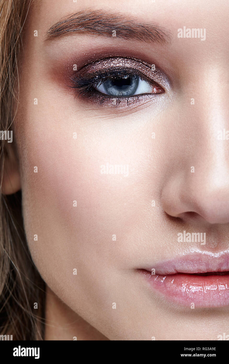 Closeup macro shot of human woman face. Female with smoky eyes makeup Stock Photo