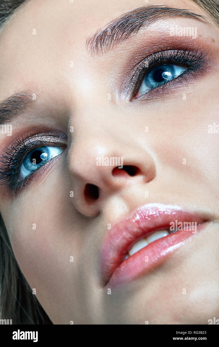 Closeup macro shot of human woman face. Female with smoky eyes makeup Stock Photo