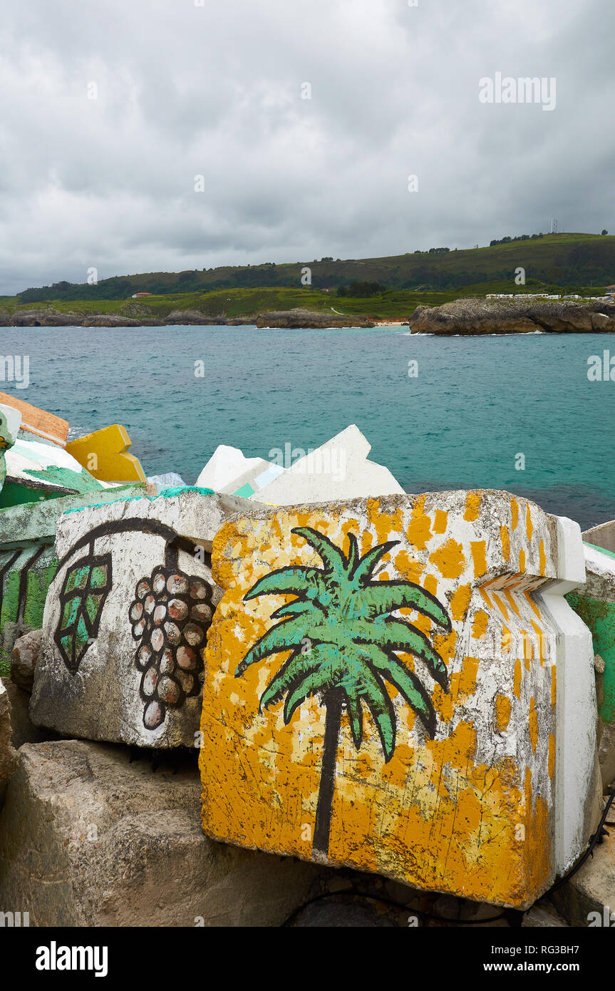 Cubos de la Memoria, artistic intervention from Agustín Ibarrola of painted concrete blocks with Cantabrian coastline (Llanes, Asturias, Spain) Stock Photo