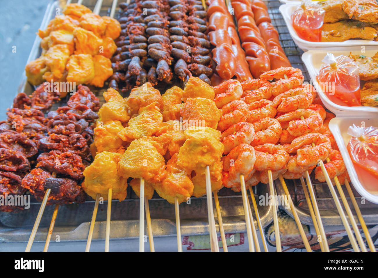 Streetfood in south east asia. Barbecue Grill Street Food in Thailand. Fried food with sticks, Thai style food Stock Photo