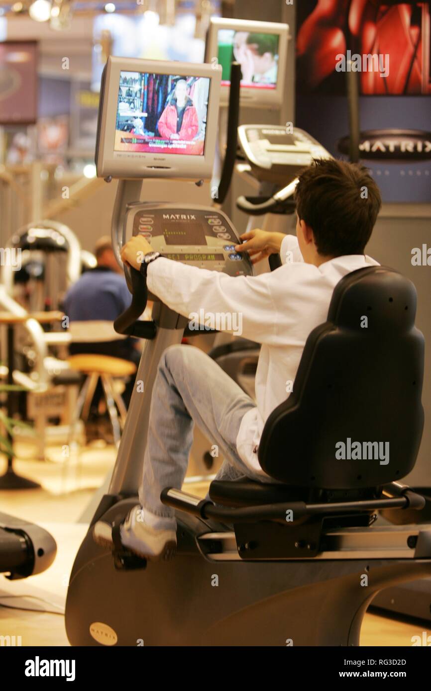 DEU, Germany, Essen : FIBO, Fitness and leisure exhibition. cycle exercise machine with tv/video screen Stock Photo
