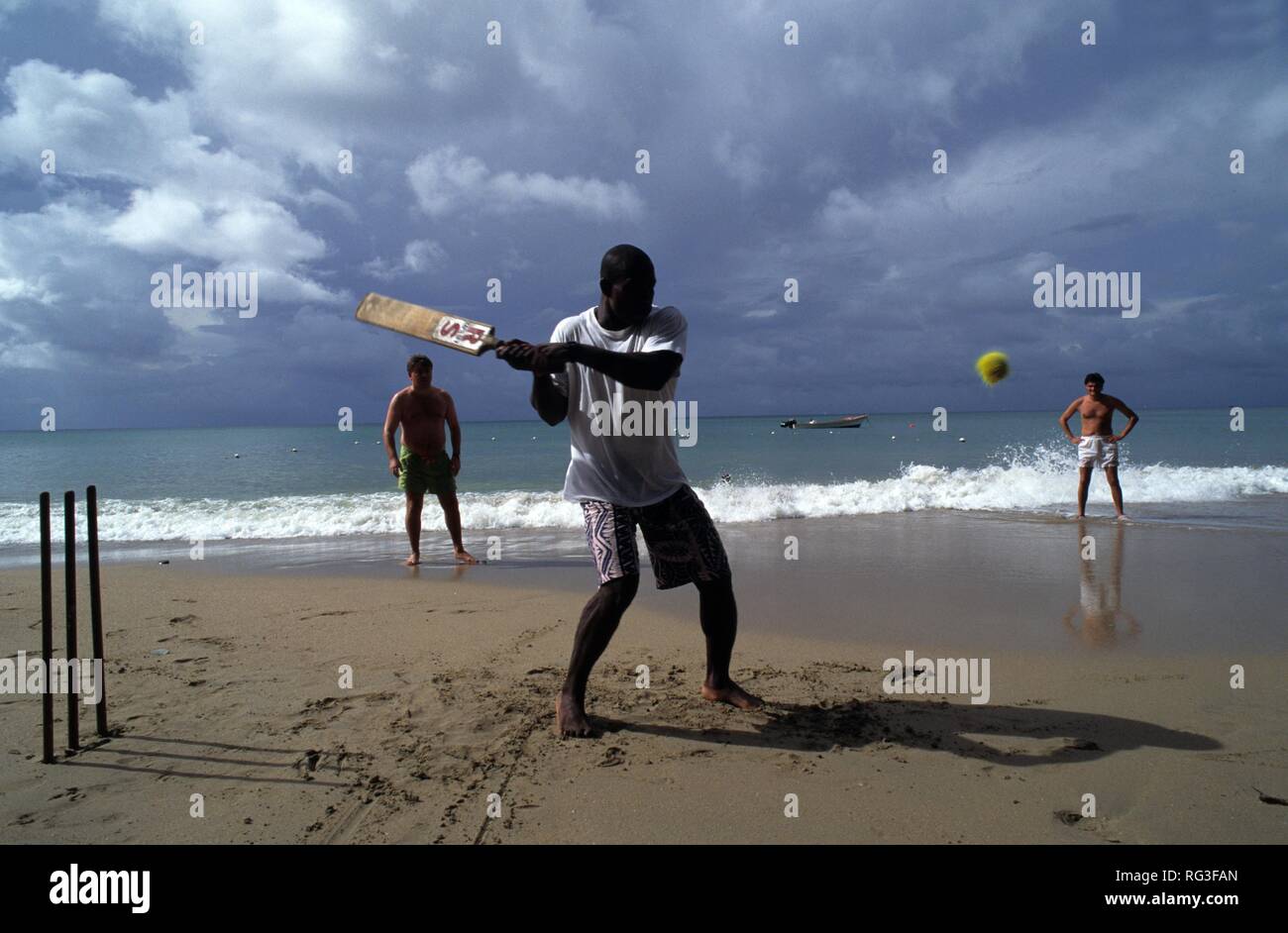 LCA, Saint Lucia: the Choc Bay near Castries, Point Seraphine. Playing cricket on the beach. Stock Photo