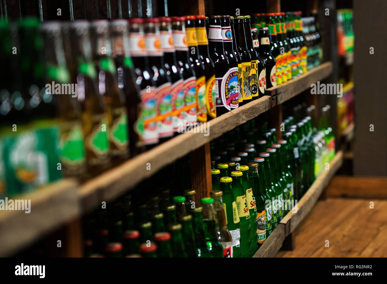 Wooden shelves of bottles of soda for sale in a shop in Indianapolis