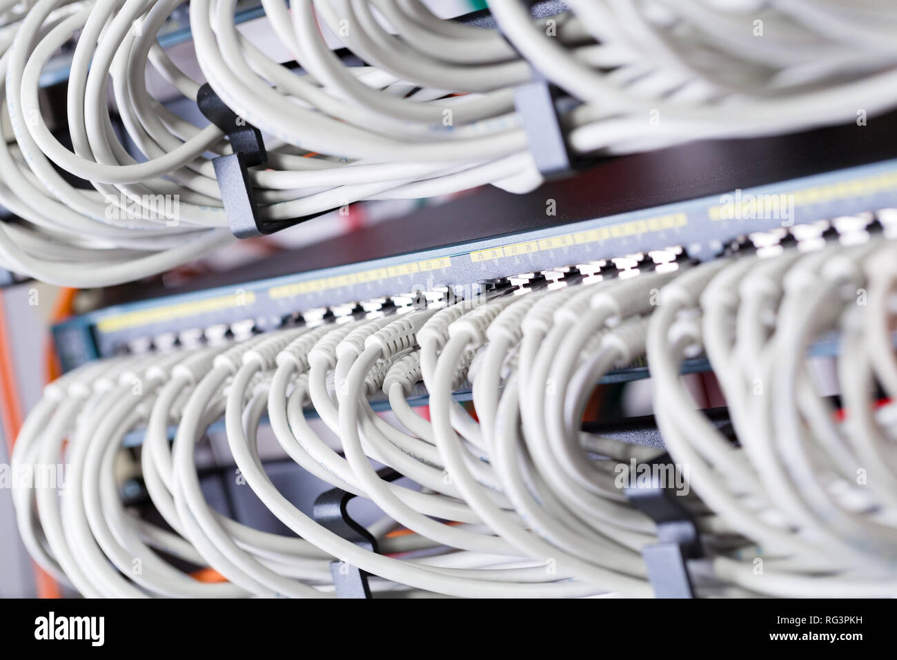 Gigabit network switch and perfect aligned patch cables in datacenter Stock Photo