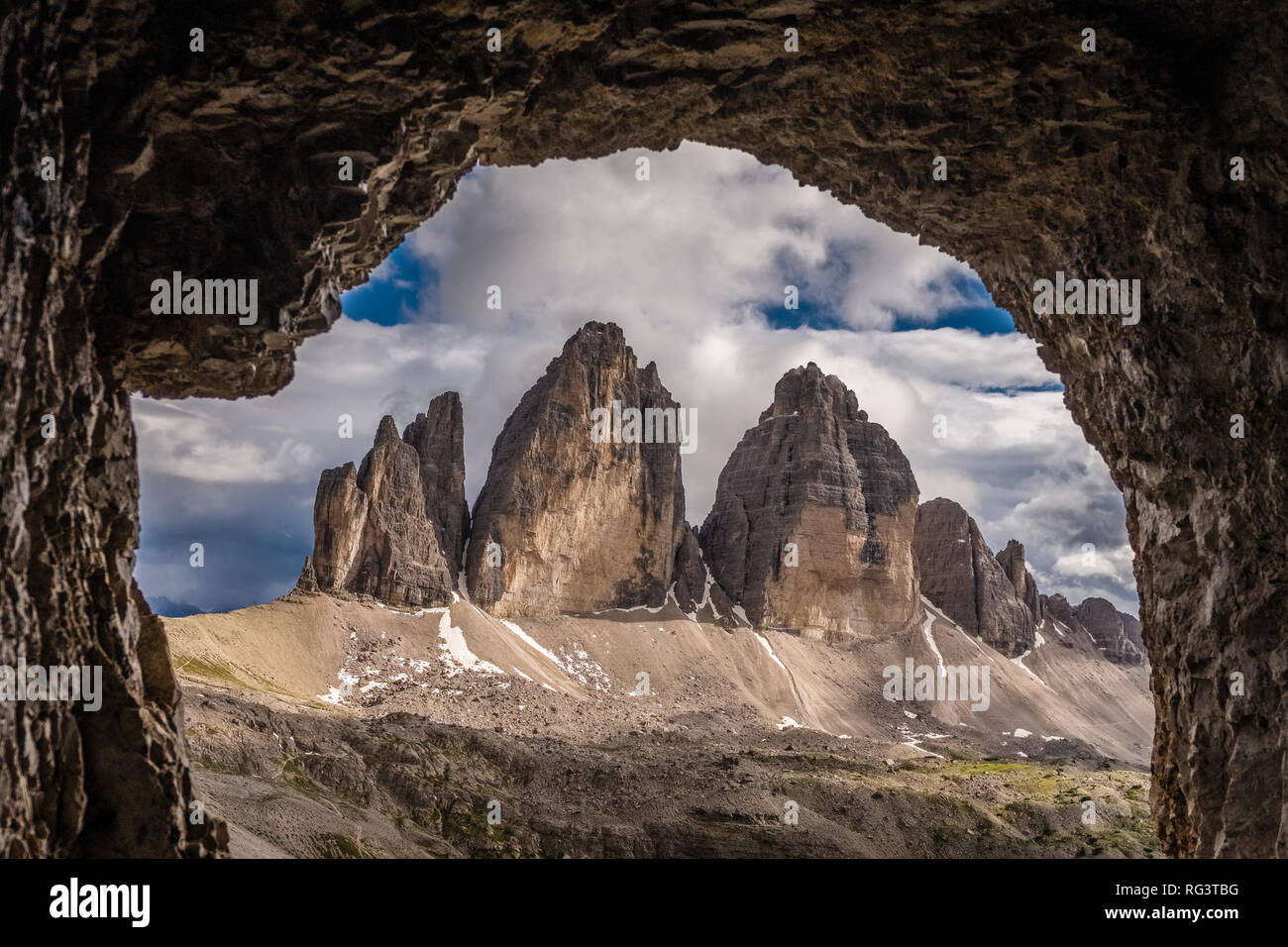 The north faces of the mountain group Tre Cime di Lavaredo, seen from a cave above the mountain hut Dreizinnenhütte Stock Photo