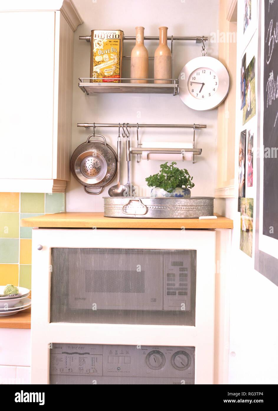 Microwave oven in kitchen cupboard with clear panel Stock Photo Alamy