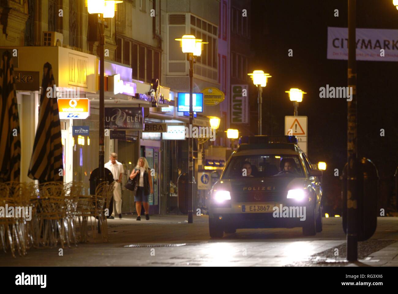 DEU, Germany, Essen: Police car at a night patrol drive in the city center, railway station. Daily police life. Officer from a Stock Photo