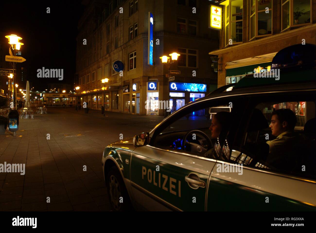DEU, Germany, Essen: Police car at a night patrol drive in the city center, railway station. Daily police life. Officer from a Stock Photo