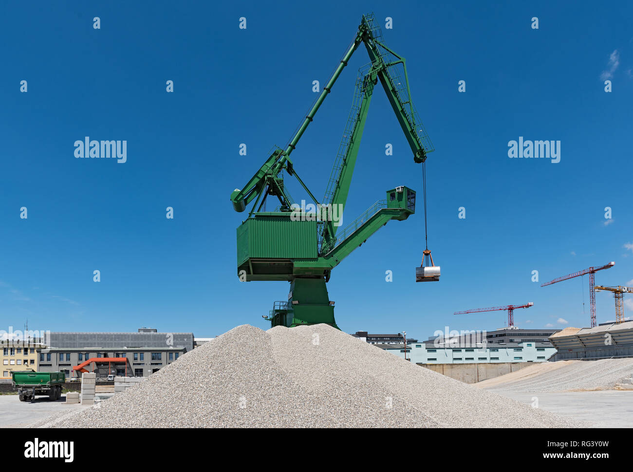 Exterior view of a cement factory with green crane Stock Photo