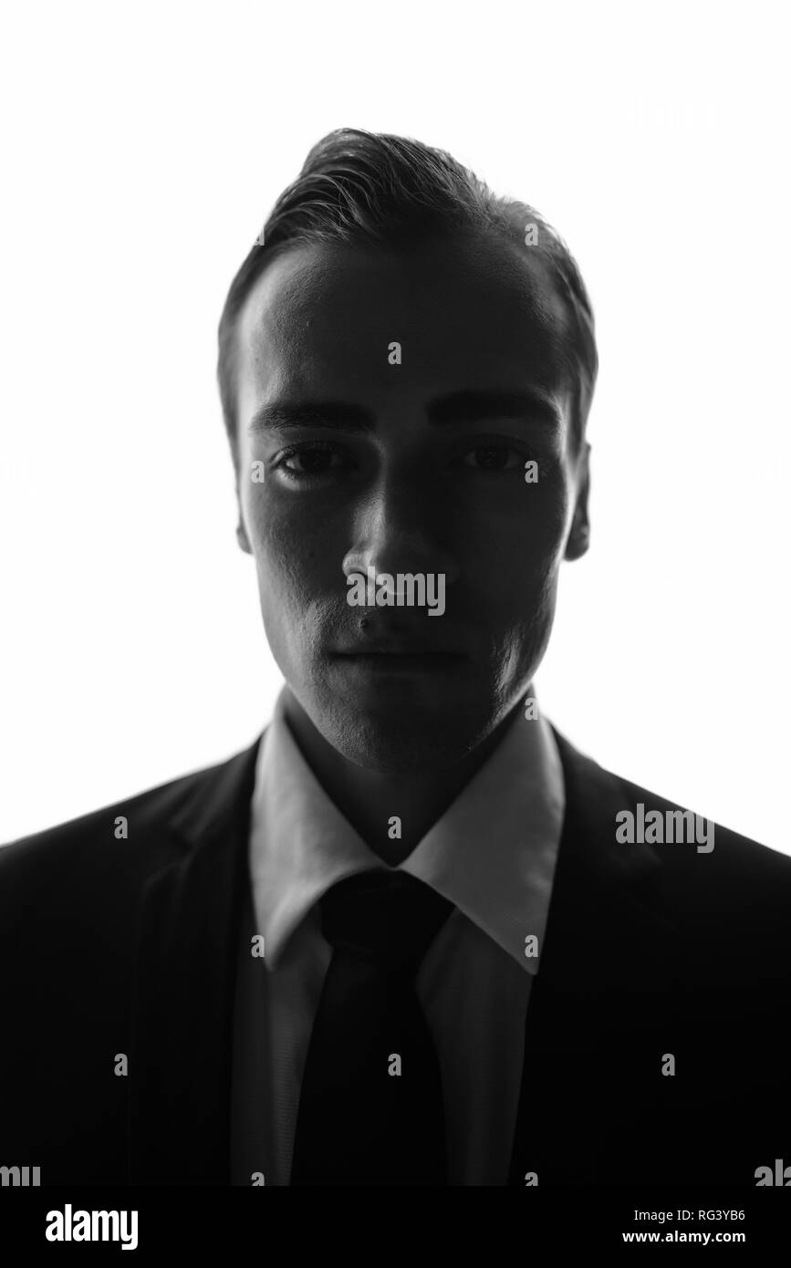 Face of young businessmanin black and white looking at camera Stock Photo