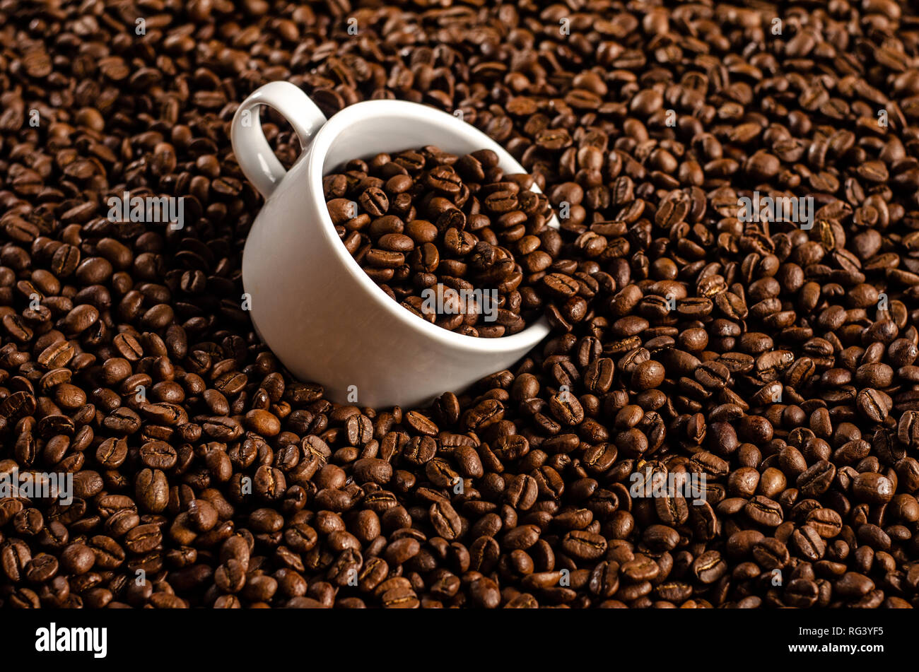 coffee beans background with white cup, copy space Stock Photo - Alamy