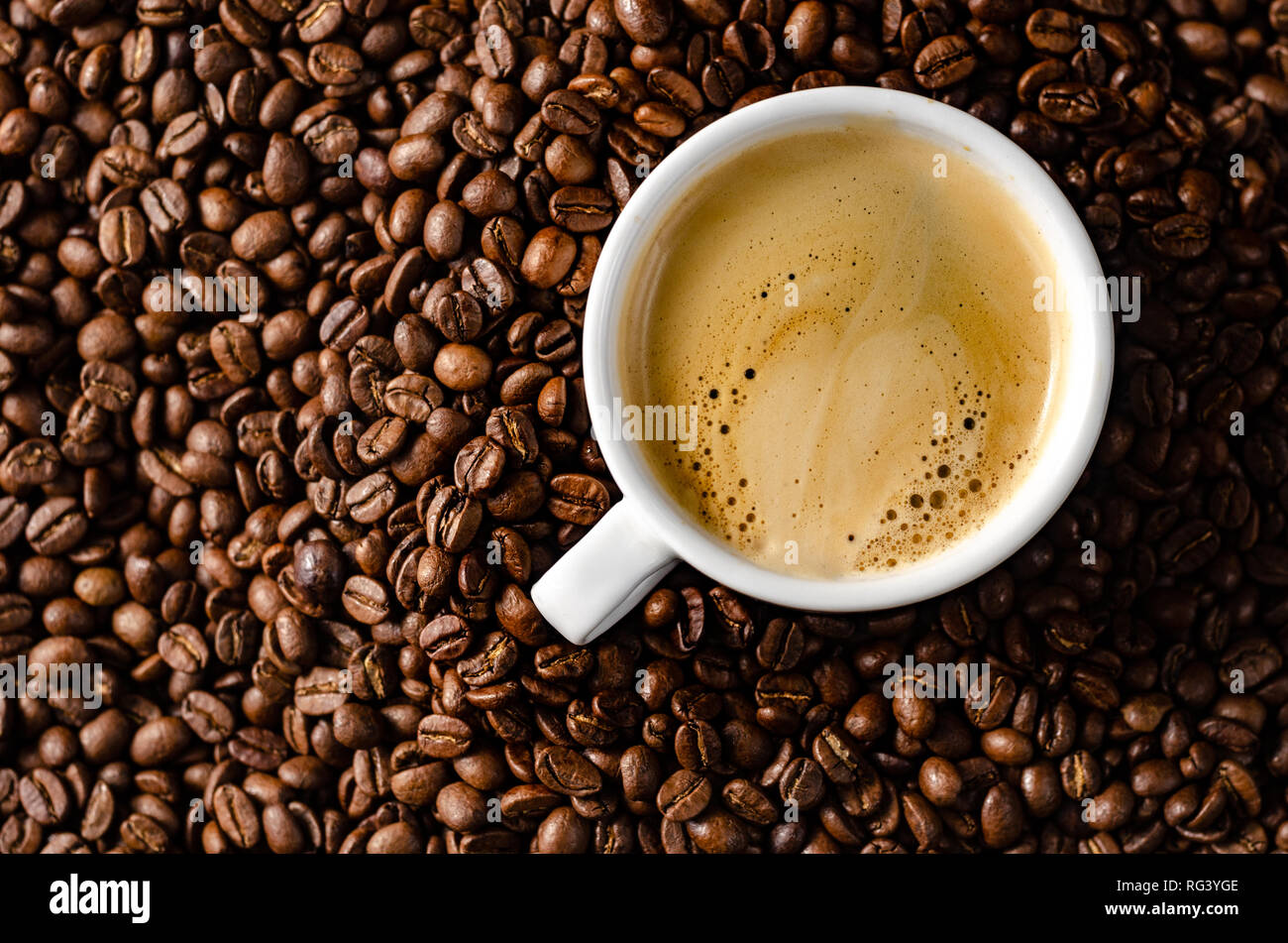 coffee beans background with white cup, copy space Stock Photo - Alamy