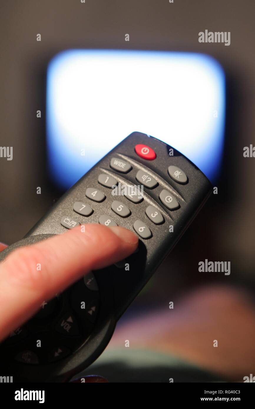 DEU, Germany : man in front of an TV. Remote control. Stock Photo