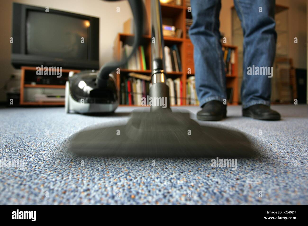 DEU, Germany : Housecleaning in a private house/apartment, vacuum cleaning. Stock Photo