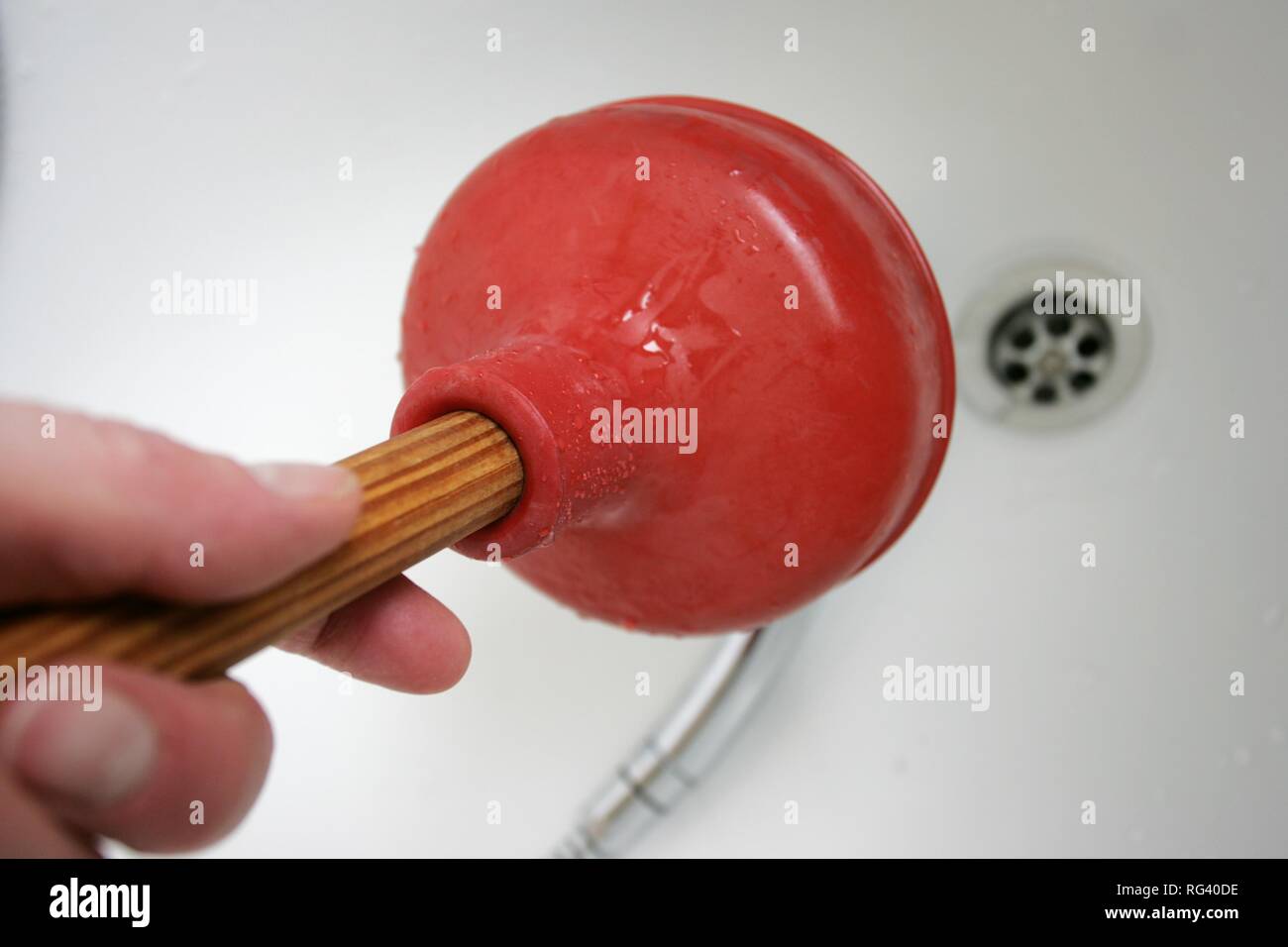 DEU, Germany Housecleaning in a private house/apartment. Cleaning of a blocked outflow in a