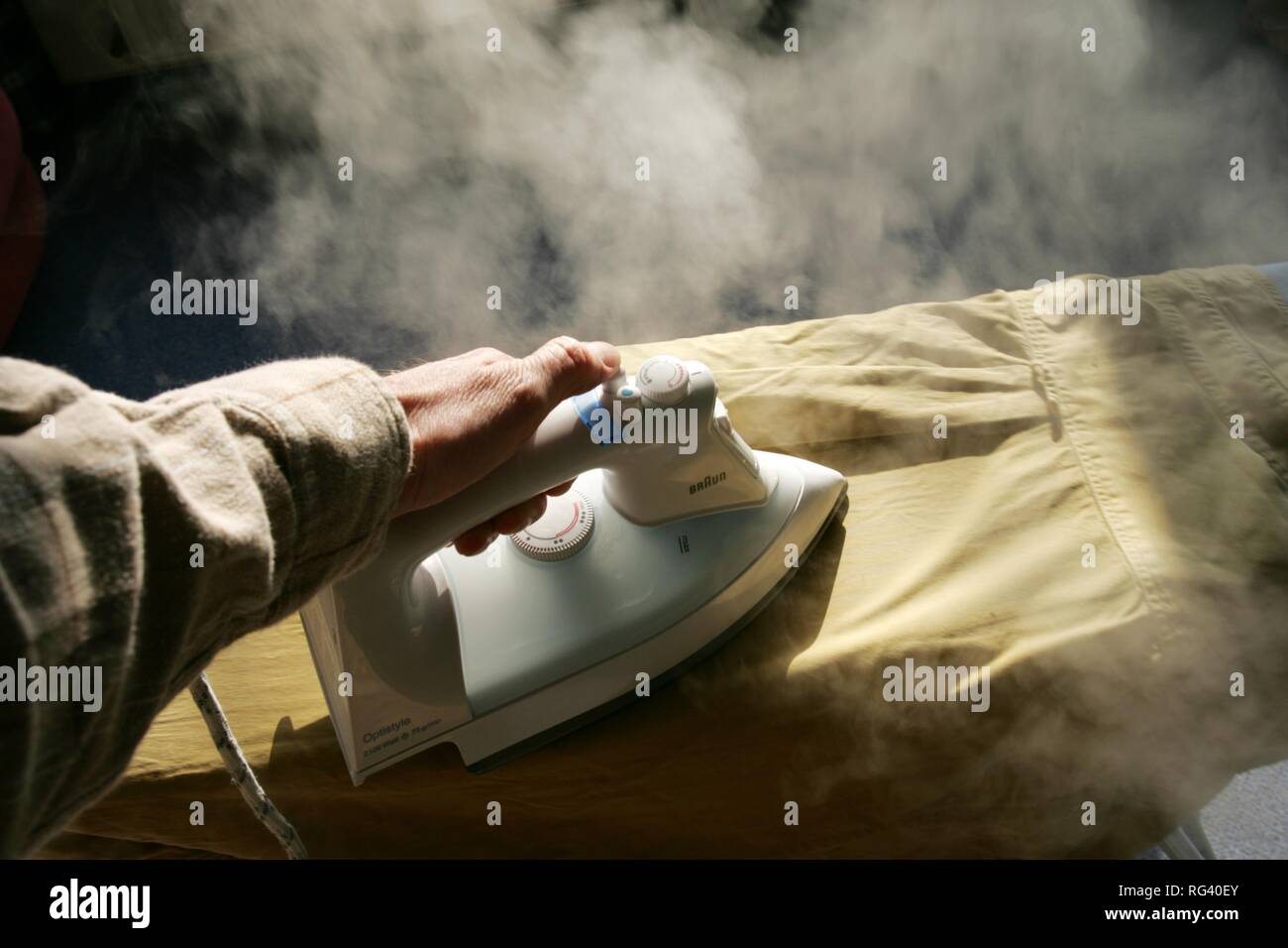 DEU, Germany : Iron of laundry at home. Steam iron. Stock Photo