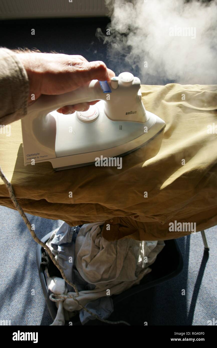 DEU, Germany : Iron of laundry at home. Steam iron. Stock Photo