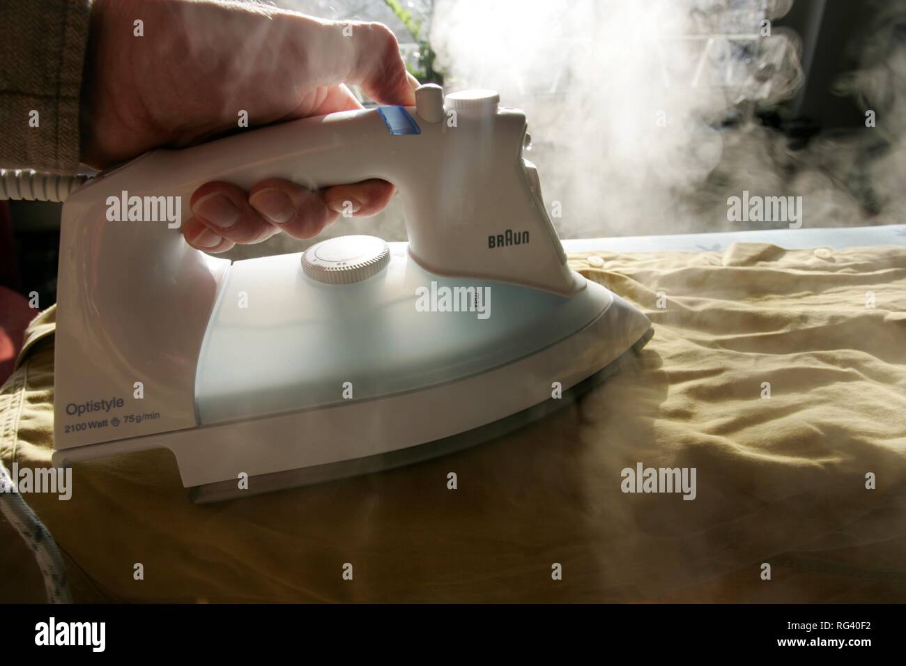 DEU, Germany : Iron of laundry at home. Steam iron. Stock Photo