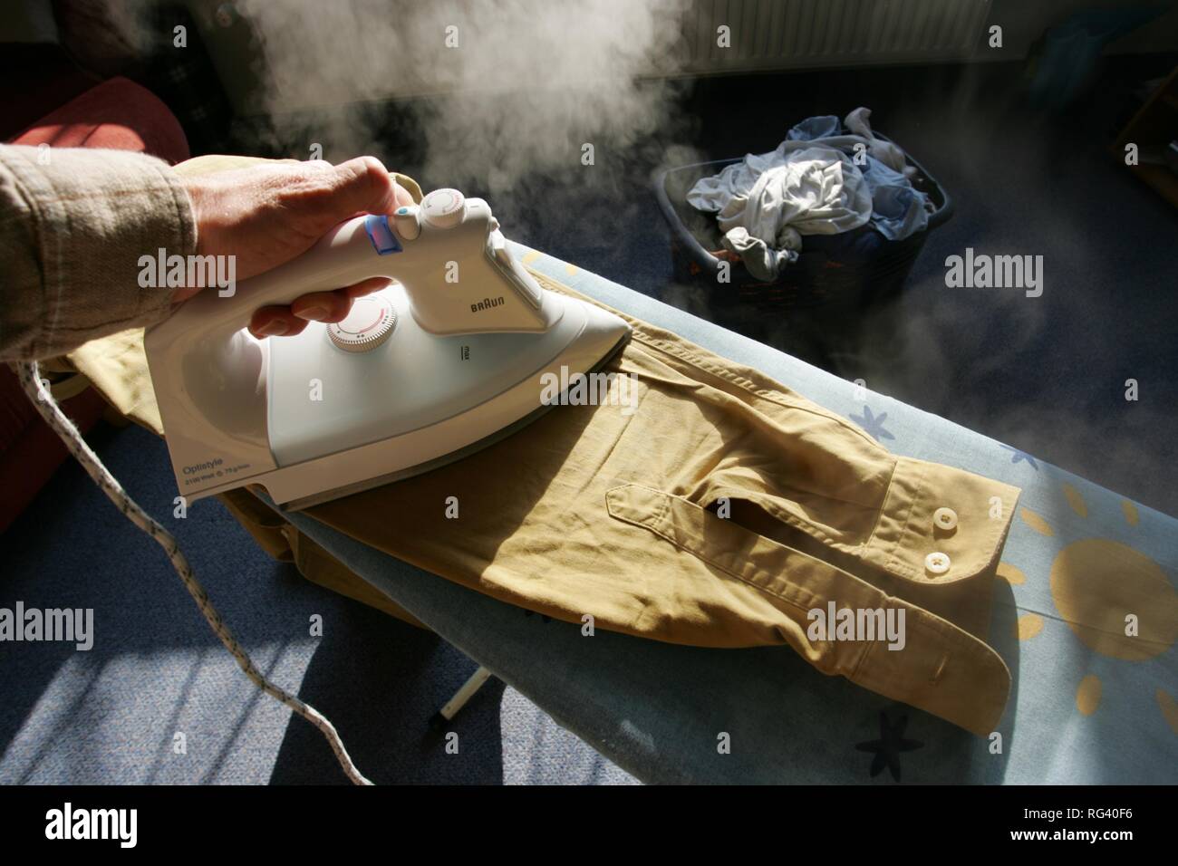 DEU, Germany : Iron of laundry at home. Steam iron. Stock Photo